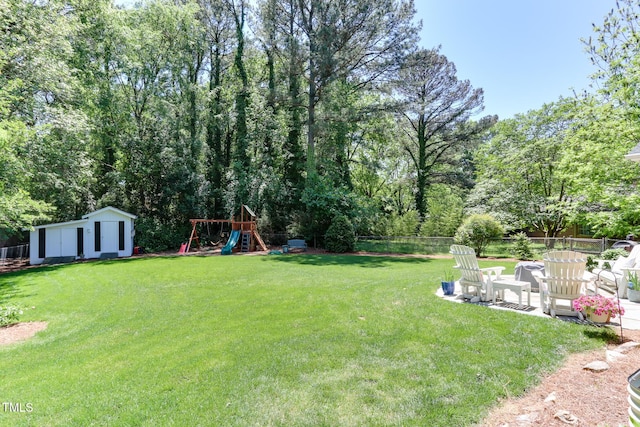 1206 Ivy Ln, Raleigh, NC 27609 - view of yard with a playground and a patio area