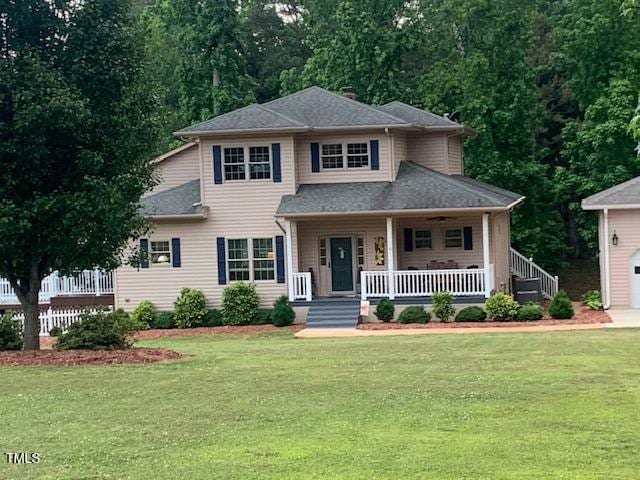 49412 River Run Rd, Albemarle, NC 28001 - view of front facade featuring covered porch, a front yard, a garage, and roof with shingles
