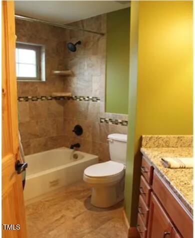 49412 River Run Rd, Albemarle, NC 28001 - bathroom with vanity, toilet, tub / shower combination, tile patterned flooring, and tile walls