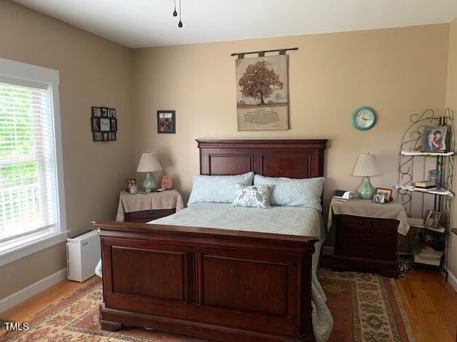 49412 River Run Rd, Albemarle, NC 28001 - bedroom featuring light wood-type flooring, multiple windows, and baseboards