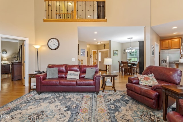 49412 River Run Rd, Albemarle, NC 28001 - living room featuring a towering ceiling, wood finished floors, a chandelier, and recessed lighting