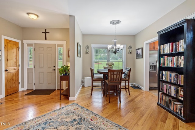 49412 River Run Rd, Albemarle, NC 28001 - dining area with light wood finished floors, a chandelier, and baseboards