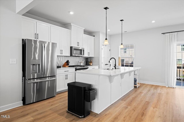 2006 Nola Ln, Durham, NC 27713 - kitchen with appliances with stainless steel finishes, a sink, light wood-style flooring, baseboards, and recessed lighting
