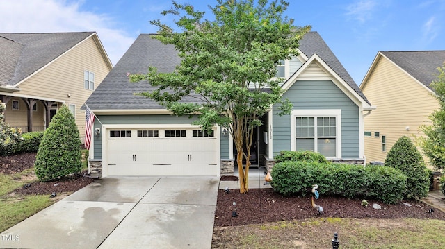 1012 Autumn Meadow Ln, Wake Forest, NC 27587 - view of front of house with driveway, stone siding, a garage, and a shingled roof