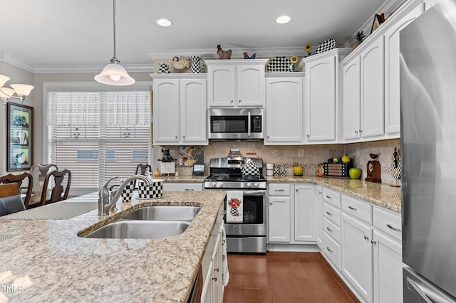 1012 Autumn Meadow Ln, Wake Forest, NC 27587 - kitchen featuring appliances with stainless steel finishes, a sink, white cabinets, decorative backsplash, and ornamental molding