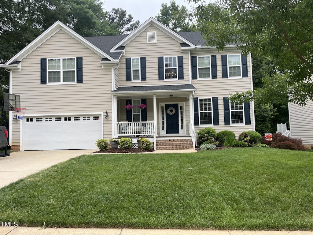 201 Forbes Rd, Wake Forest, NC 27587 - view of front of home featuring a porch, a garage, driveway, a front yard, and roof with shingles