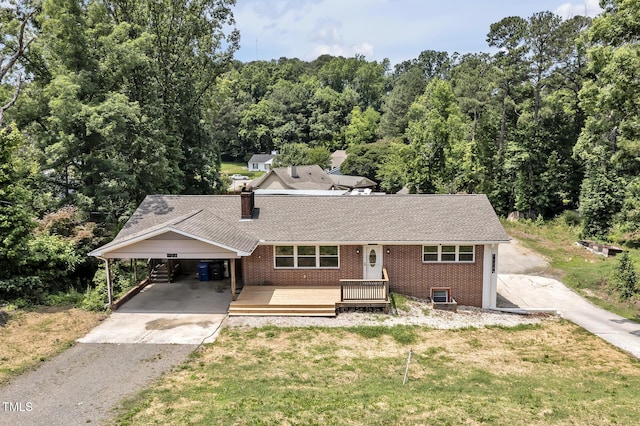 112 S Joyland St, Durham, NC 27703 - view of front of property with brick siding, driveway, a front yard, and a carport