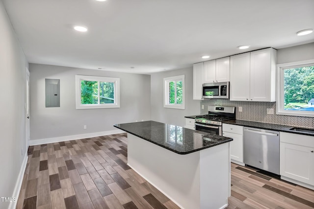 112 S Joyland St, Durham, NC 27703 - kitchen featuring stainless steel appliances, healthy amount of natural light, white cabinets, and recessed lighting