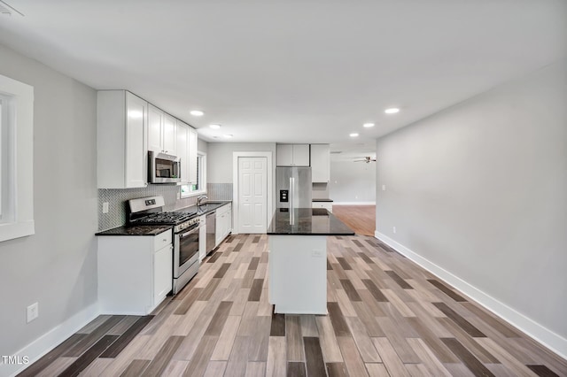 112 S Joyland St, Durham, NC 27703 - kitchen with stainless steel appliances, light wood-type flooring, baseboards, recessed lighting, and ceiling fan