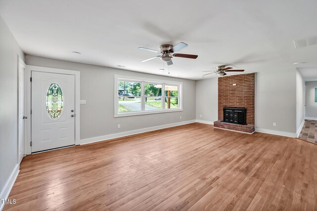 112 S Joyland St, Durham, NC 27703 - unfurnished living room with light wood-style floors, ceiling fan, baseboards, and a fireplace
