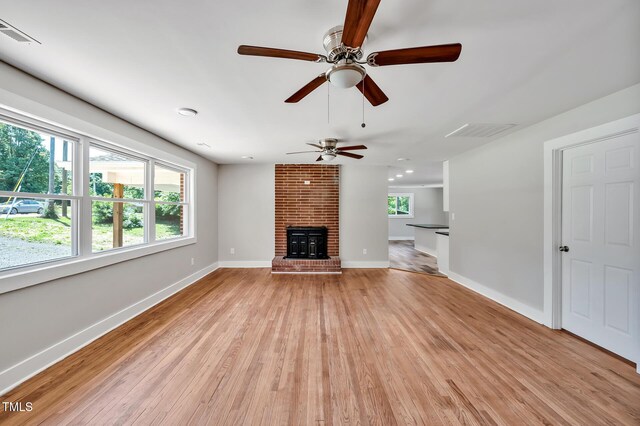 112 S Joyland St, Durham, NC 27703 - unfurnished living room featuring a ceiling fan, light wood-style flooring, baseboards, and a fireplace