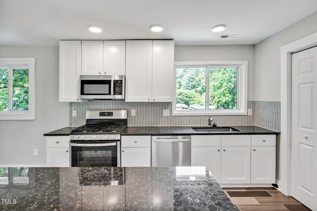 112 S Joyland St, Durham, NC 27703 - kitchen with stainless steel appliances, a sink, and white cabinetry