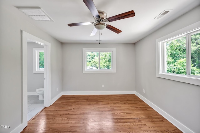 112 S Joyland St, Durham, NC 27703 - spare room featuring healthy amount of natural light, ceiling fan, wood finished floors, and baseboards