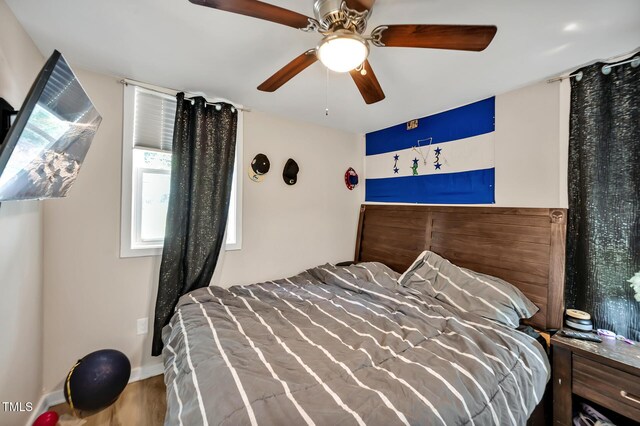 112 S Joyland St, Durham, NC 27703 - bedroom with wood finished floors, ceiling fan, and baseboards
