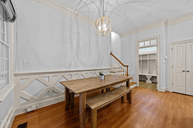 1711 Happiness Hill Ln, Raleigh, NC 27614 - dining area with crown molding, light wood finished floors, a chandelier, and stairs