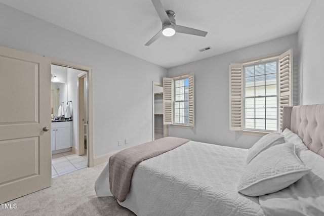 1711 Happiness Hill Ln, Raleigh, NC 27614 - bedroom with light tile patterned floors, light colored carpet, ensuite bathroom, and a ceiling fan