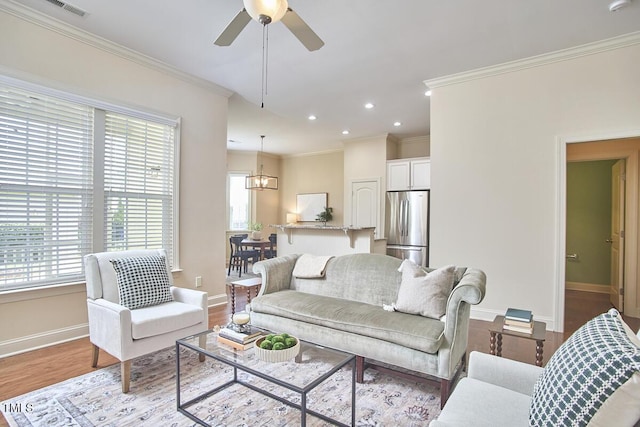 808 Historian St, Raleigh, NC 27603 - living area featuring ornamental molding, recessed lighting, wood finished floors, ceiling fan, and a chandelier