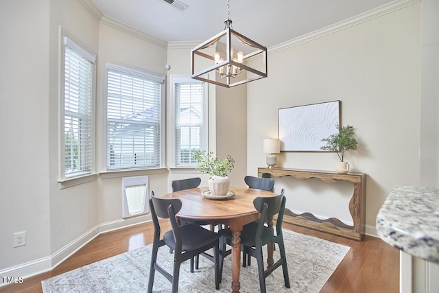 808 Historian St, Raleigh, NC 27603 - dining area with a chandelier, wood finished floors, and ornamental molding