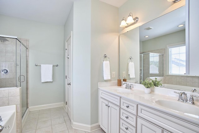 808 Historian St, Raleigh, NC 27603 - full bathroom with a bath, double vanity, a stall shower, and tile patterned flooring