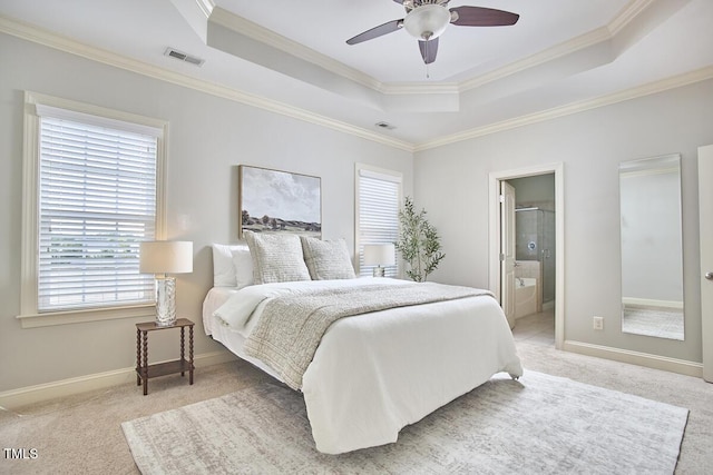 808 Historian St, Raleigh, NC 27603 - bedroom featuring a tray ceiling, multiple windows, light carpet, ornamental molding, and connected bathroom