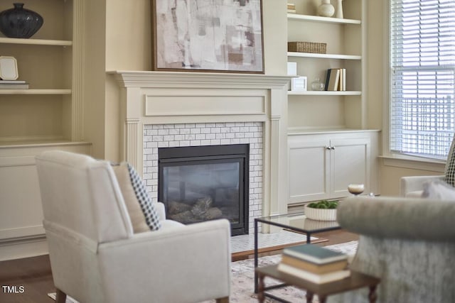 808 Historian St, Raleigh, NC 27603 - living area with built in shelves, dark wood-style floors, and a fireplace