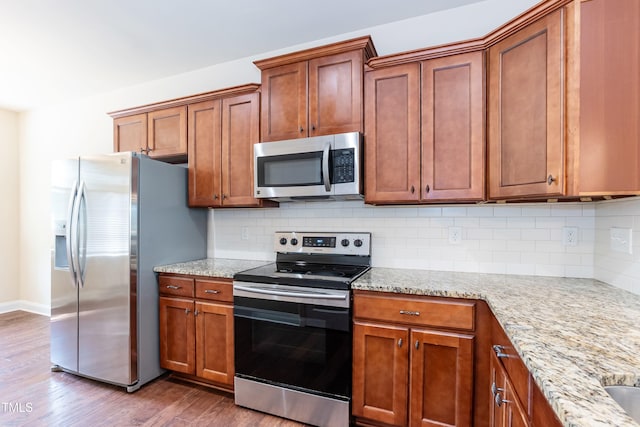 2808 Carter Finley Pl, Raleigh, NC 27606 - kitchen with stainless steel appliances, dark wood-type flooring, brown cabinetry, light stone countertops, and decorative backsplash
