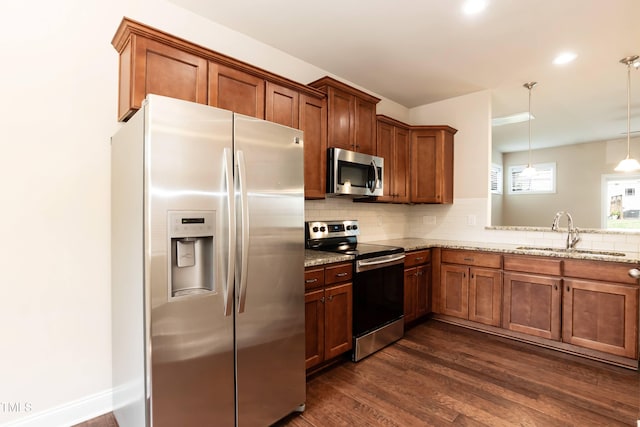 2808 Carter Finley Pl, Raleigh, NC 27606 - kitchen with stainless steel appliances, tasteful backsplash, dark wood-type flooring, light stone counters, and brown cabinetry