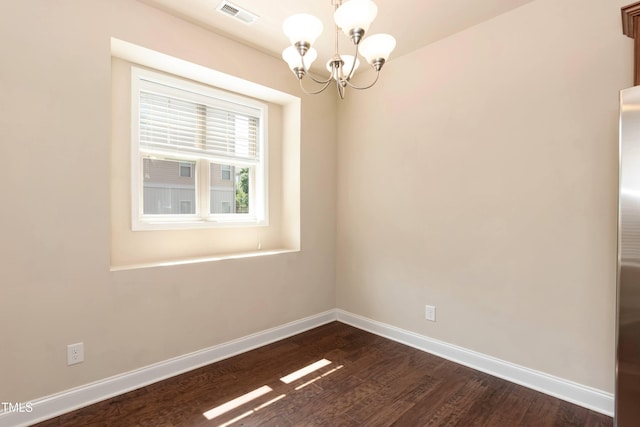 2808 Carter Finley Pl, Raleigh, NC 27606 - spare room featuring a chandelier and dark wood-type flooring