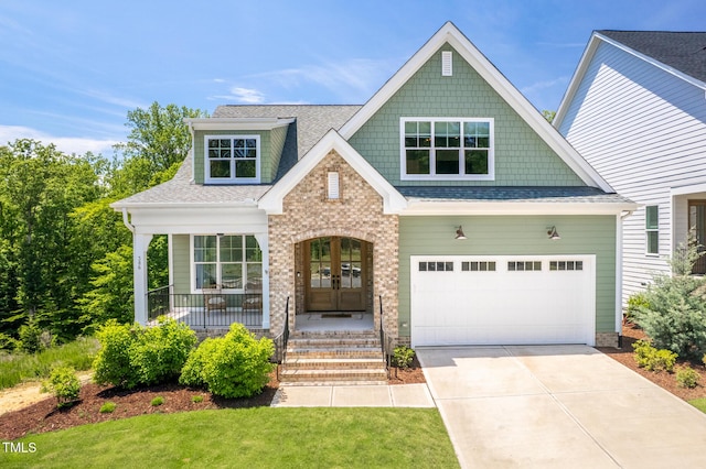386 Monteith Dr, Chapel Hill, NC 27516 - craftsman-style house featuring french doors, driveway, roof with shingles, a front yard, and a porch