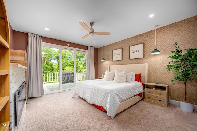 386 Monteith Dr, Chapel Hill, NC 27516 - bedroom featuring access to exterior, carpet flooring, a fireplace, wallpapered walls, and ceiling fan