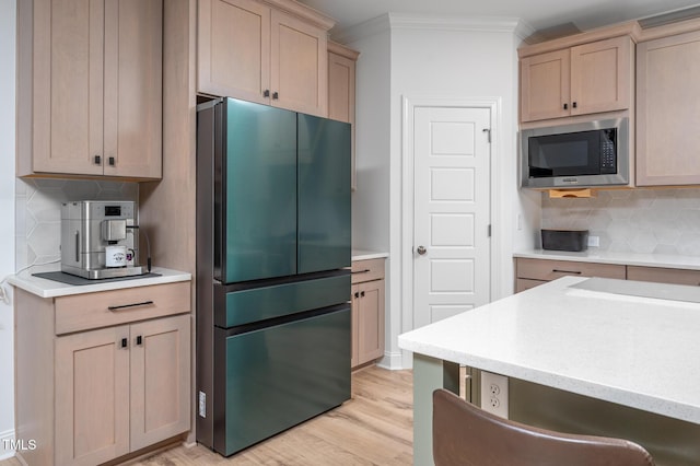 386 Monteith Dr, Chapel Hill, NC 27516 - kitchen with freestanding refrigerator, stainless steel microwave, decorative backsplash, light countertops, and ornamental molding