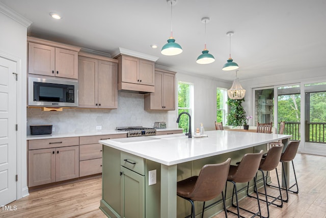 386 Monteith Dr, Chapel Hill, NC 27516 - kitchen with stainless steel microwave, decorative backsplash, ornamental molding, light countertops, and light wood-style floors
