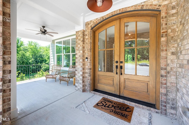 386 Monteith Dr, Chapel Hill, NC 27516 - entrance to property featuring french doors, covered porch, ceiling fan, and brick siding