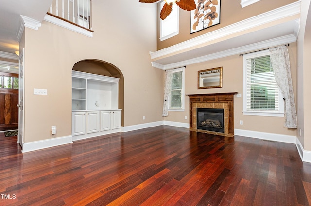 2201 Karns Pl, Raleigh, NC 27614 - unfurnished living room with wood finished floors, a tiled fireplace, ceiling fan, a towering ceiling, and ornamental molding