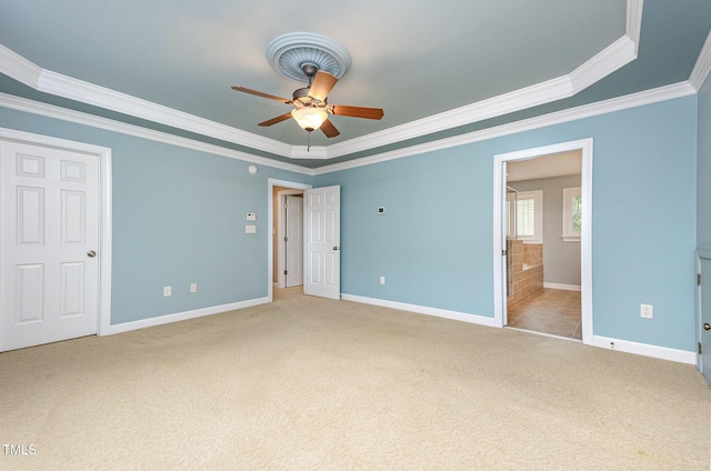 2201 Karns Pl, Raleigh, NC 27614 - unfurnished bedroom featuring crown molding, light colored carpet, a tray ceiling, ensuite bath, and ceiling fan