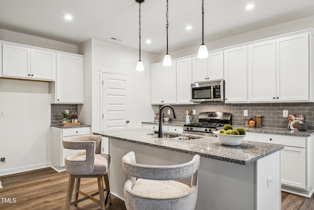 149 Cribbs Ln, Middlesex, NC 27557 - kitchen with appliances with stainless steel finishes, a sink, decorative backsplash, dark wood-type flooring, and white cabinetry