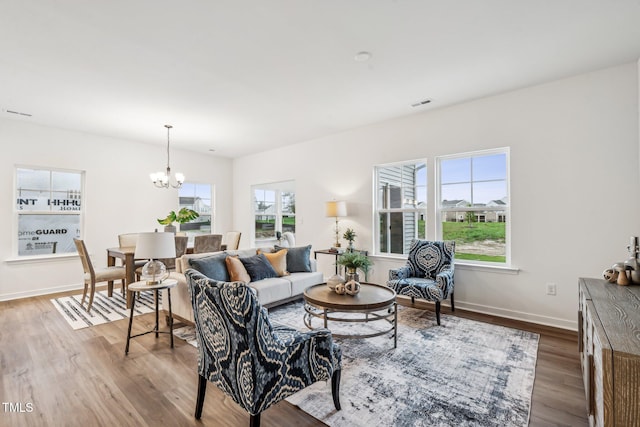 149 Cribbs Ln, Middlesex, NC 27557 - living area featuring a chandelier, healthy amount of natural light, wood finished floors, and baseboards