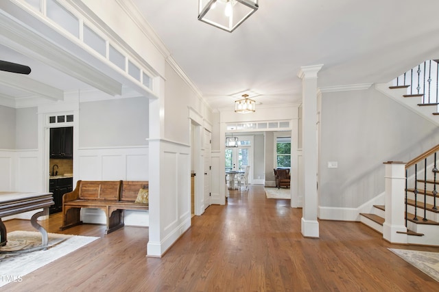 101 Eden Glen Dr, Holly Springs, NC 27540 - foyer entrance featuring stairs, a decorative wall, wood finished floors, ornamental molding, and wainscoting