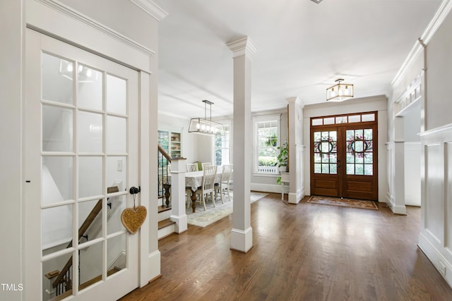 101 Eden Glen Dr, Holly Springs, NC 27540 - entrance foyer featuring french doors, ornamental molding, a chandelier, wood finished floors, and decorative columns