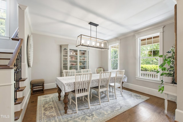 101 Eden Glen Dr, Holly Springs, NC 27540 - dining area featuring a chandelier, crown molding, wood finished floors, baseboards, and stairs