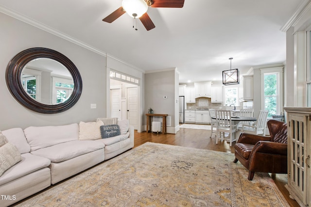 101 Eden Glen Dr, Holly Springs, NC 27540 - living area featuring ceiling fan, plenty of natural light, wood finished floors, and ornamental molding