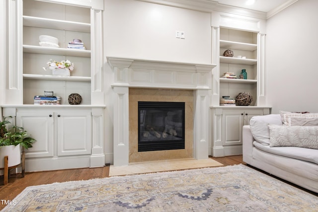 101 Eden Glen Dr, Holly Springs, NC 27540 - living area featuring crown molding, wood finished floors, built in features, and a fireplace