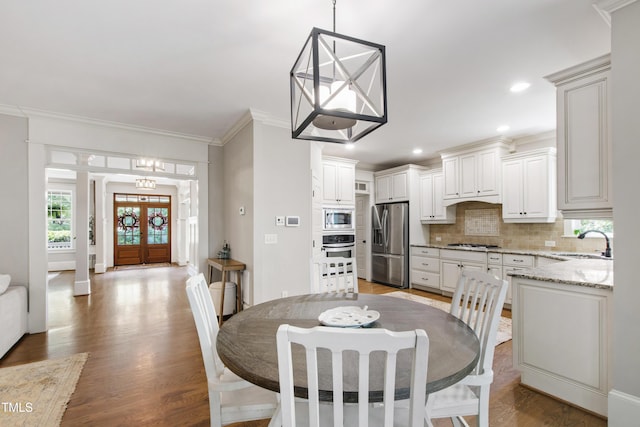 101 Eden Glen Dr, Holly Springs, NC 27540 - dining area with crown molding, light wood-style flooring, recessed lighting, and a chandelier