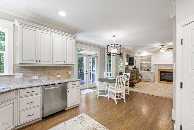 101 Eden Glen Dr, Holly Springs, NC 27540 - kitchen featuring stainless steel dishwasher, plenty of natural light, light wood finished floors, ceiling fan, and crown molding