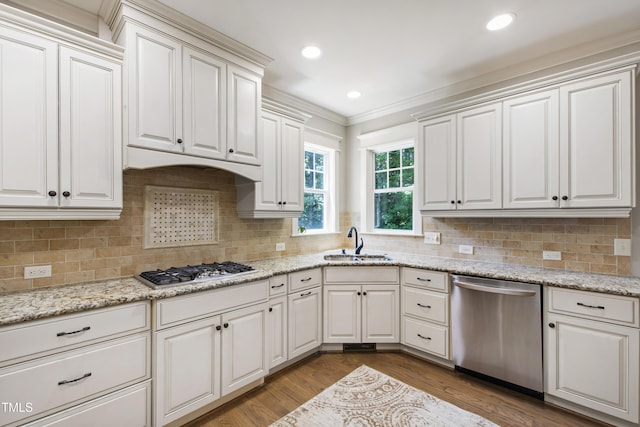 101 Eden Glen Dr, Holly Springs, NC 27540 - kitchen with stainless steel appliances, a sink, dark wood-style flooring, crown molding, and decorative backsplash
