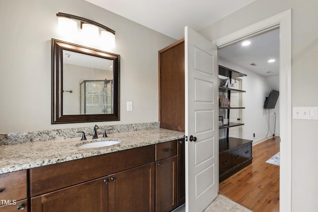 101 Eden Glen Dr, Holly Springs, NC 27540 - full bathroom featuring vanity, wood finished floors, recessed lighting, and a shower