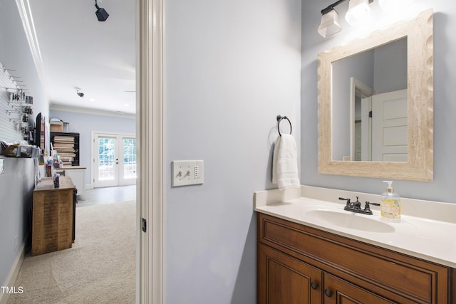 101 Eden Glen Dr, Holly Springs, NC 27540 - bathroom with french doors, vanity, and ornamental molding