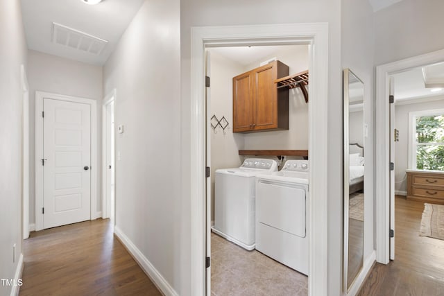101 Eden Glen Dr, Holly Springs, NC 27540 - laundry area with separate washer and dryer, cabinet space, wood finished floors, and baseboards