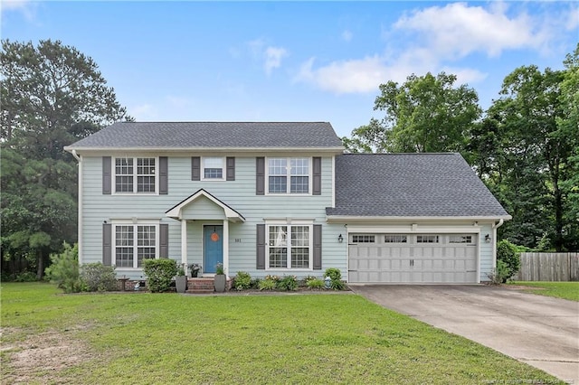 101 Quiet Cv, Raeford, NC 28376 - colonial house with driveway, a garage, and a shingled roof