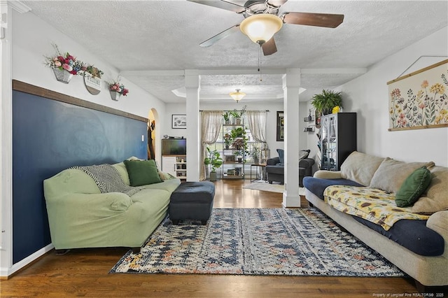 101 Quiet Cv, Raeford, NC 28376 - living area featuring decorative columns, a textured ceiling, wood finished floors, and ceiling fan